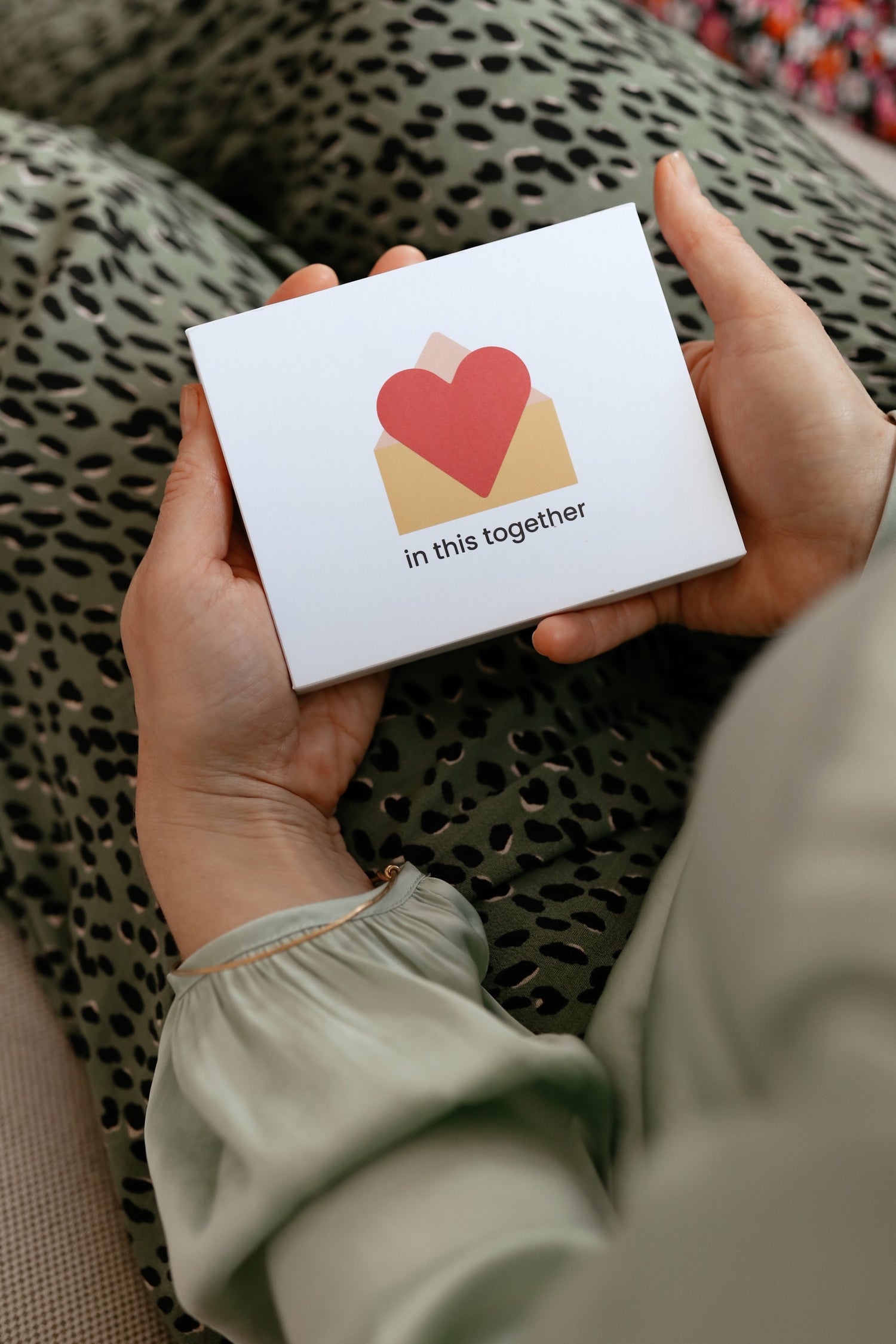 Founder Rosie, holding a box of 12 in this together cards: the perfect gift for any new Mum. 